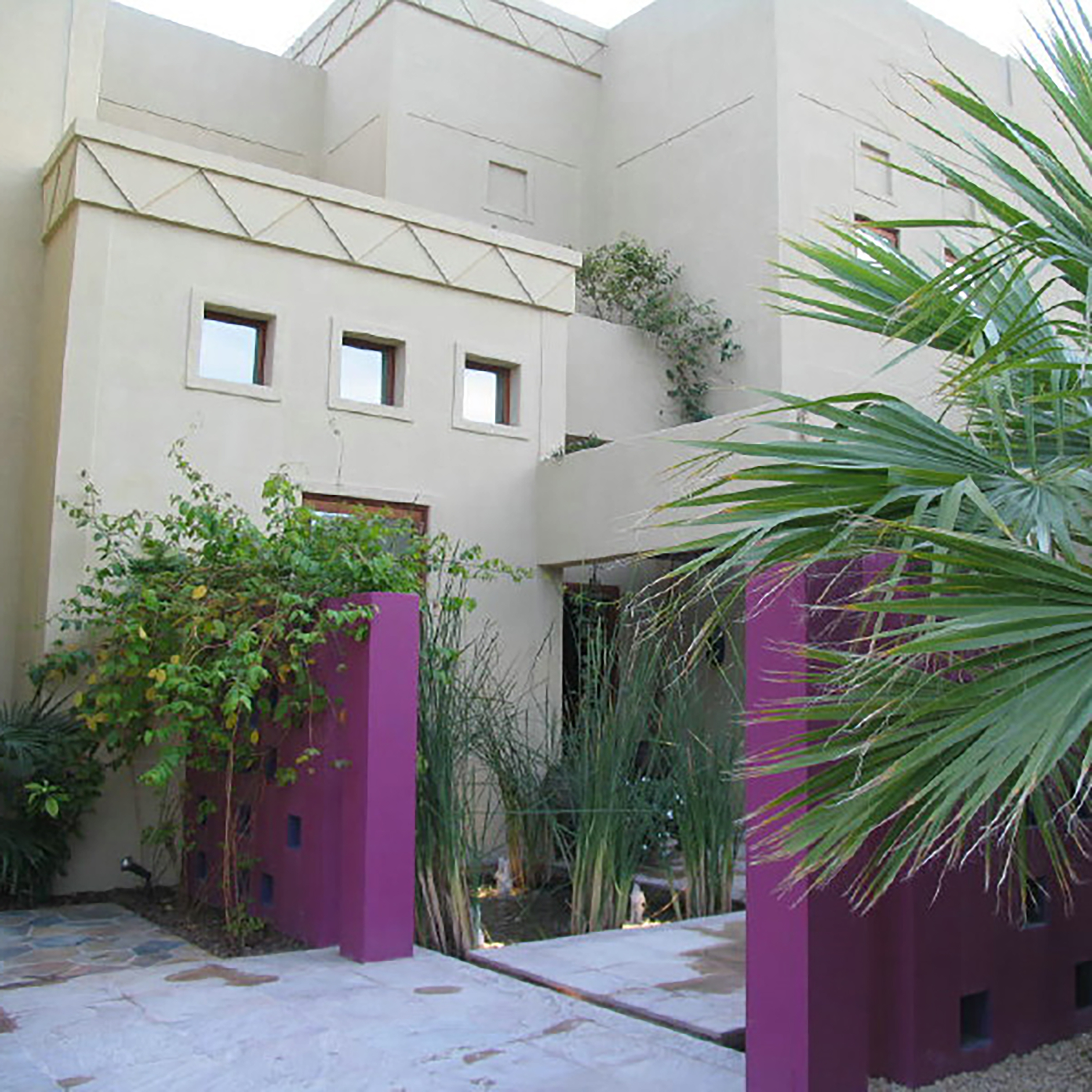 The Villa had to comply with strict external planning guidelines.  The purple screen walls provided a bit of whimsy once entering the property.