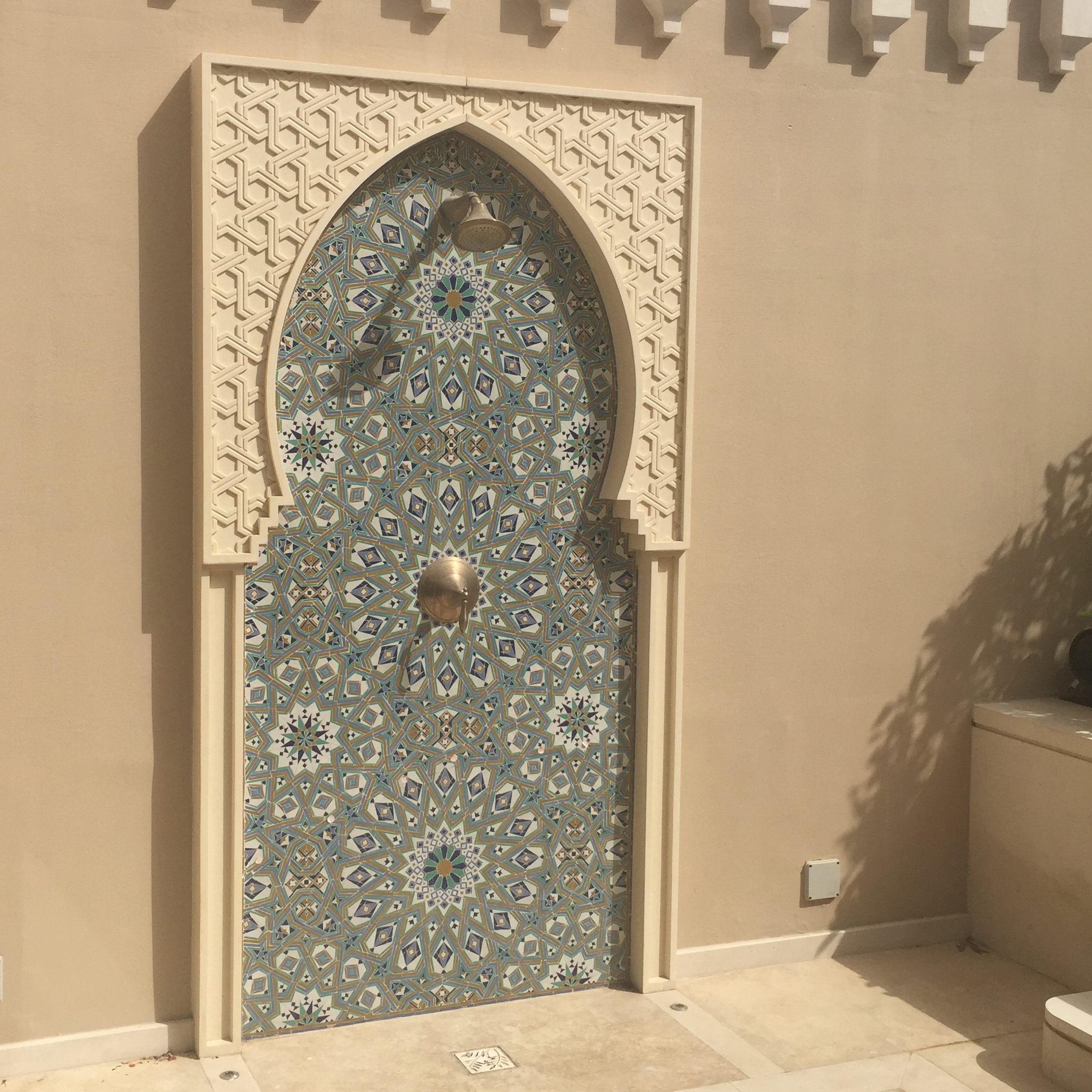 Custom zellij tiles were imported from Morocco for the outdoor shower.